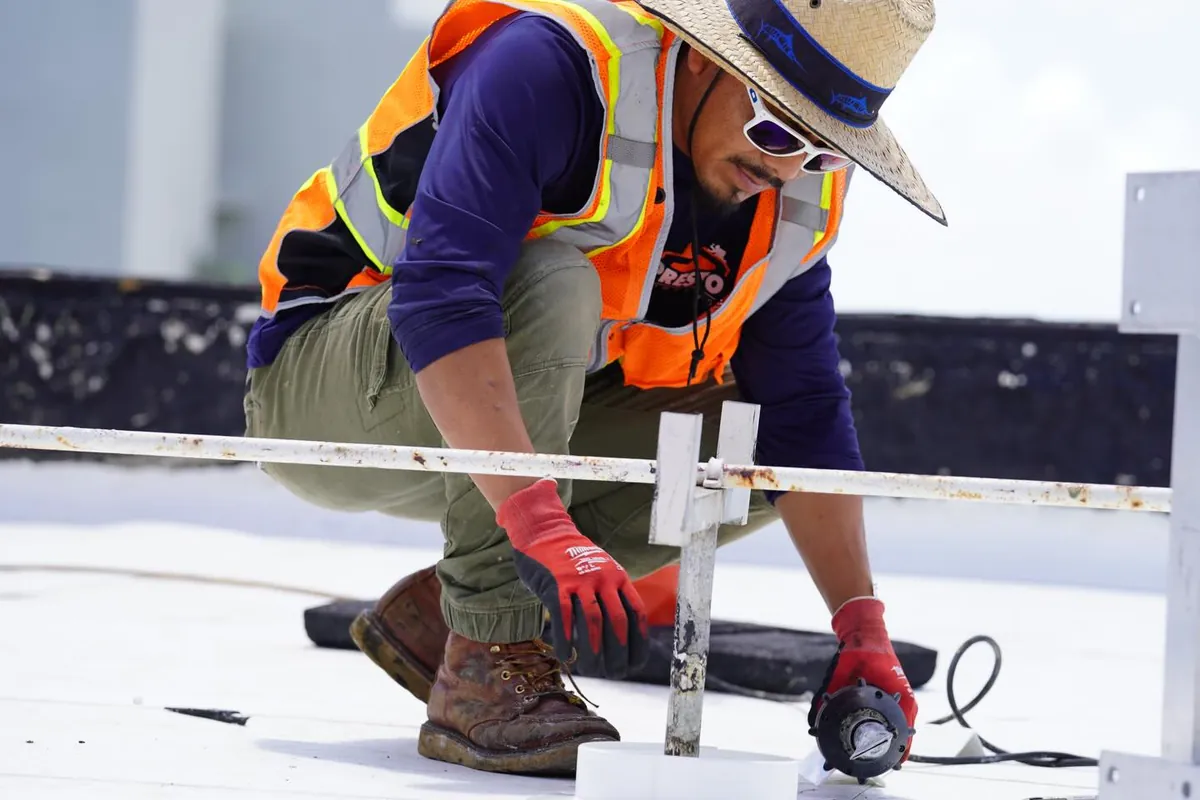 Technician installing flat roof flashing