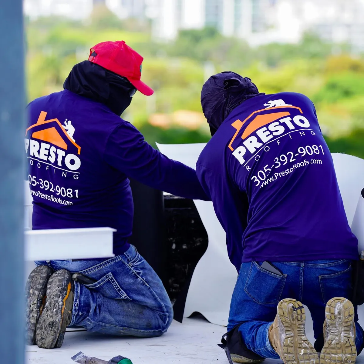 Two technicians from behind, branded jerseys
